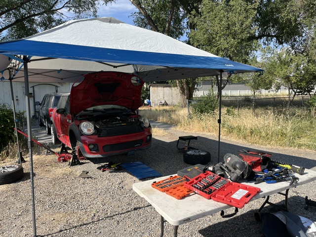 Mobile mechanic setup with canopy and tools